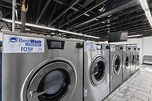 a row of washing machines in Sat Louis laundromat in Watson Road, one of Best Wash Laundromats locations