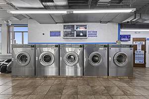 a row of washing machines in Best Wash Laundromats in West Main location