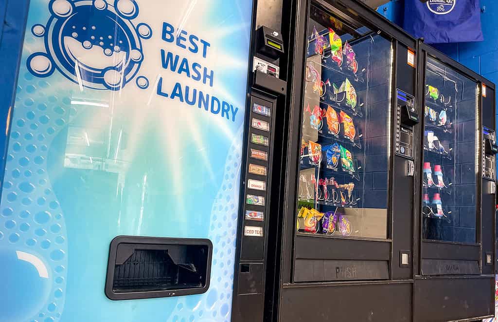 a vending machine with a best wash laundromats sign and a drink dispenser inside Dunn Road, Florissant laundromat location