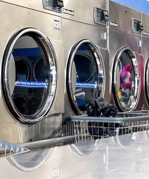 a row of circular washing machines in Dunn Road, Florissant Laundromat